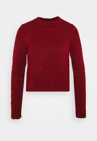 Punainen neulepaita, jossa on pyöreä pääntie ja pitkät hihat. Ominaisuuksiin kuuluu ribbaatut hihansuut ja helma. Teksturoitu kangas, joka luo mukavan ilmeen.