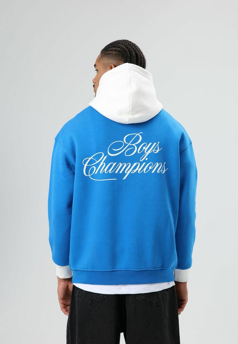 Blauwe hoodie met witte capuchon. Tekst "Boys Champions" in wit cursief op de achterkant. Gemaakt van katoen, losse pasvorm, geribbelde boorden en zoom.