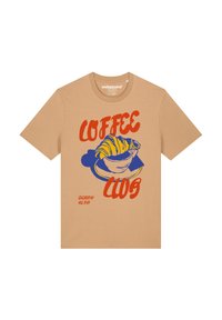 Beige t-shirt met korte mouwen met een kleurrafisch van een croissant en een kopje met de tekst "COFFEE CLUB" in vet rood en blauw.