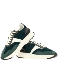 Löparskor med en överdel i teal och grått, vita accenter, texturerade paneler och en tjock vit sula med svart mönster. Har snörning.