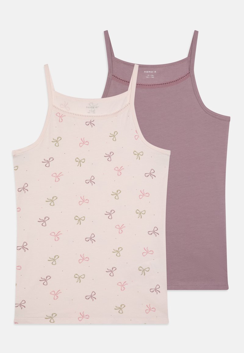 Two tank tops: one light pink with multi-colored bow patterns, and one solid plum. Both made of soft cotton with thin straps.