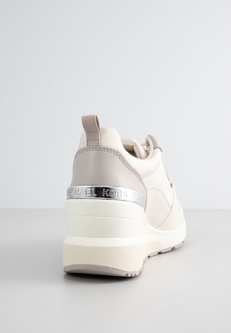 Sneaker beige e grigio con un tacco rialzato, suola in gomma, tessuto testurizzato e dettaglio in metallo sul retro.