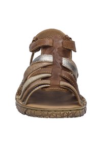 Brown leather sandal with metallic silver accents, open-toe design, adjustable straps, and textured sole featuring a geometric pattern.