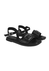 Black leather sandals with open toe design, featuring two wide straps and a metallic accent. Buckle closure and flat rubber sole.