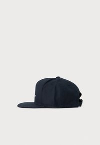 Navy blue adjustable baseball cap with flat brim, six-panel construction, and small embroidered details on front and top button.