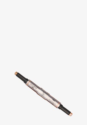 Stick per trucco a doppia estremità con applicatore cremoso color oro, caratterizzato da un design elegante in nero e argento metallizzato; etichettato "COLORFIX STIX."