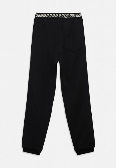 Black casual jogger pants with elastic waistband featuring a black and white geometric pattern and a single back pocket on the right side.