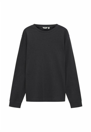 Haut à manches longues noir en tissu en maille gaufrée texturée. Doté d'un col rond et d'une coupe décontractée avec des poignets et un ourlet côtelés.