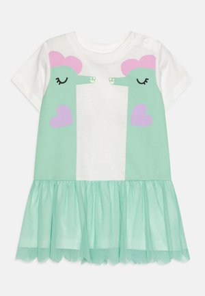 Robe vert menthe avec un haut blanc aux visages illustrés, des accents roses et une jupe en tulle à volants. Tissu en coton doux. Boutons-pression à l'épaule.