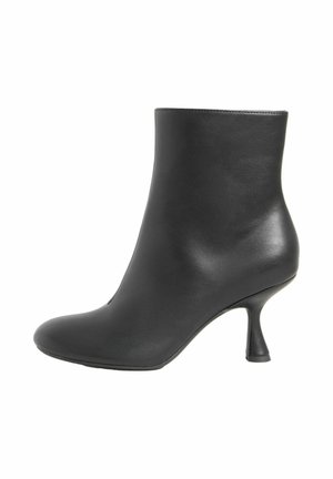 Zwarte enkelboot gemaakt van soepel leer met een slanke, gebogen hak. Voorzien van een ronde punt en een naadloos ontwerp voor een elegante uitstraling.