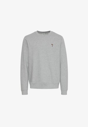 Hall hõbedast puuvillane dressipluus, millel on ümmargune kaelus, soonikkoes mansetid ja alläär. Rinna kohal on väike tikand.