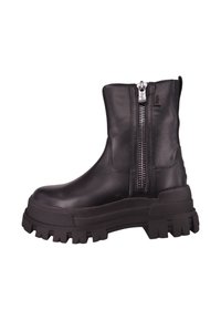 Botas negras de cuero hasta el tobillo con una suela gruesa, cremallera lateral, textura suave y diseño minimalista. Cuenta con una suela de goma gruesa con relieves.