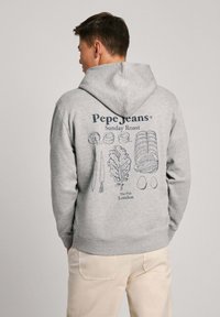 Siva dukserica s kapuljačom s plavim grafičkim otiskom na leđima, koji prikazuje namirnice i tekst "Pepe Jeans Sunday Roast The Pub London." Materijal od pamuka.