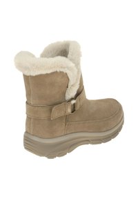 Bruine suède enkellaarzen met nepbontvoering, verstelbare banddetails en een getextureerde rubberen zool. Zacht, warm en geschikt voor winterkleding.