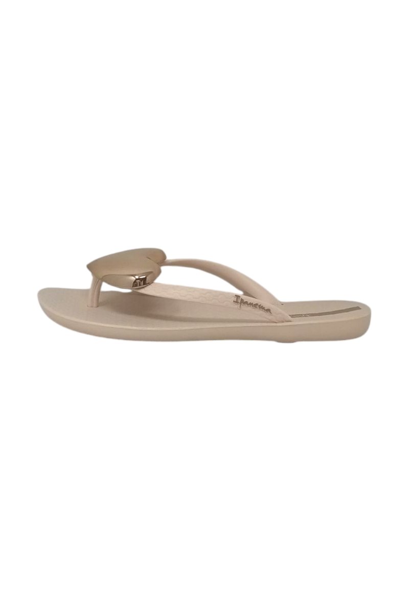 Infradito color beige con un design minimalista, dotate di un cinturino a forma di cuore e una suola liscia e piatta per comfort e facilità d'uso.
