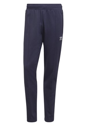 Granatowe dresowe spodnie marki Adidas z elastycznym pasem, przednimi kieszeniami na zamek błyskawiczny oraz logo Adidas na górnej części uda.