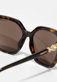 Swarovski Solbriller - dark havana/dark brown