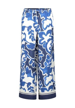 Bukser med vide ben i hvidt stof med dristige blå blomsterprints. Elastisk linning med snøre og marineblå kant forneden.