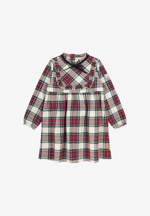 Geruite jurk met lange mouwen, ruches bij de halslijn, met rood, groen en marineblauw ruitpatroon op een crèmekleurige achtergrond. Gemaakt van katoen.