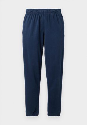 Navyblå mjukisbyxor gjorda av mjukt tyg, med elastisk midja och smalnande ben med elastiska muddar. Inga synliga mönster eller dekorationer.