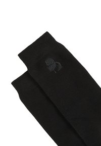 Fekete pamutszharu zoknik sima textúrával, diszkrét logó részlettel, amely egy kicsit világosabb fekete árnyalatban helyezkedik el a tetején.