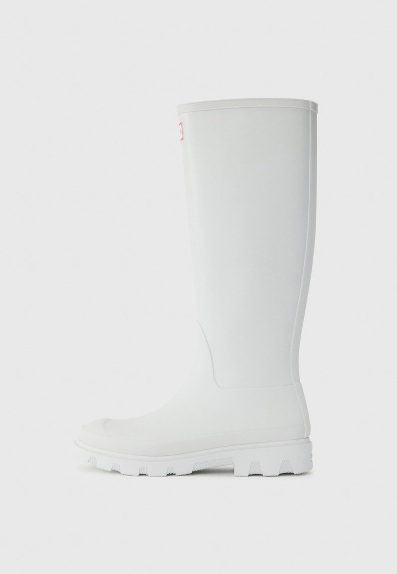 White rubber knee-length boot featuring a rounded toe, textured sole, and smooth exterior with subtle branding. Designed for unisex wear.