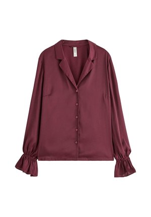 Burgundy silkesblus med långa ärmar, knappstängning fram, spetsig krage och volangärmar. Slät textur med avslappnad passform.