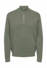 Jasnozielony sweter typu pulower z wysokim kołnierzem i zamkiem do ćwiartki długości. Wykonany z fakturowanej tkaniny z długimi rękawami.