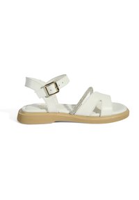 White leather sandal with a velcro strap and gold buckle. Features a cushioned footbed and a light brown rubber sole. Subtle silver accent.