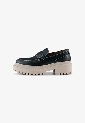 Black leather loafers with a textured beige platform sole, featuring white stitching and a rounded toe design.