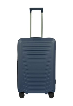 Blue hard-shell suitcase with embossed horizontal lines, retractable aluminum handle, and four black wheels for mobility.
