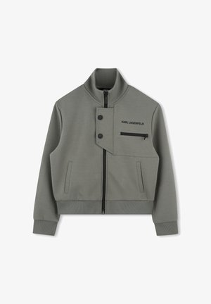 Veste grise avec un col montant, fermeture éclair et accents en bouton. Dispose d'une poche avant zippée et d'une texture de tissu structurée.
