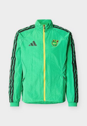 Grøn sportjakke med sorte Adidas-striber på ærmerne, gul lynlås og Jamaica-emblem på brystet.