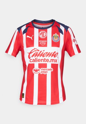 Red and white striped soccer jersey with short sleeves, featuring blue accents on the shoulders, logos, and text in bold white.