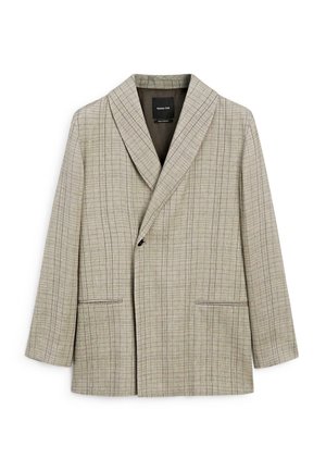 Blazer beige clair avec un motif à carreaux. Dispose d'un col châle, d'une fermeture par bouton central et de deux poches avant. Finition textile lisse.