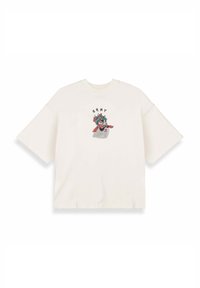 Camiseta de gran tamaño color crema con mangas cortas que presenta un diseño gráfico colorido de una cara y el texto "GRMY" arriba.
