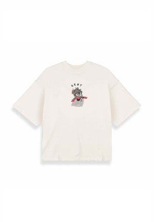 T-shirt oversize color crema con maniche corte, caratterizzato da un design grafico colorato di un volto e il testo "GRMY" sopra di esso.