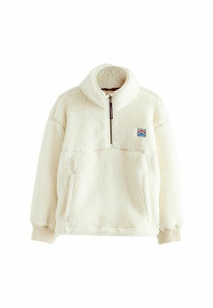 Sudadera de forro polar en color blanco roto, con cuello alto, media cremallera, puños de canalé y bolsillo tipo canguro en la parte delantera. Parche con logo en la parte superior izquierda.