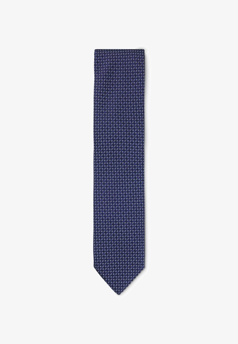 Cravate bleu marine avec un motif géométrique blanc, faite d'un tissu lisse, arborant une forme classique étroite et une pointe pointue.