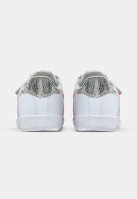 White sneakers with pink accents, textured grey heel, and soft mint green lining. Rounded toe and flat rubber sole design.