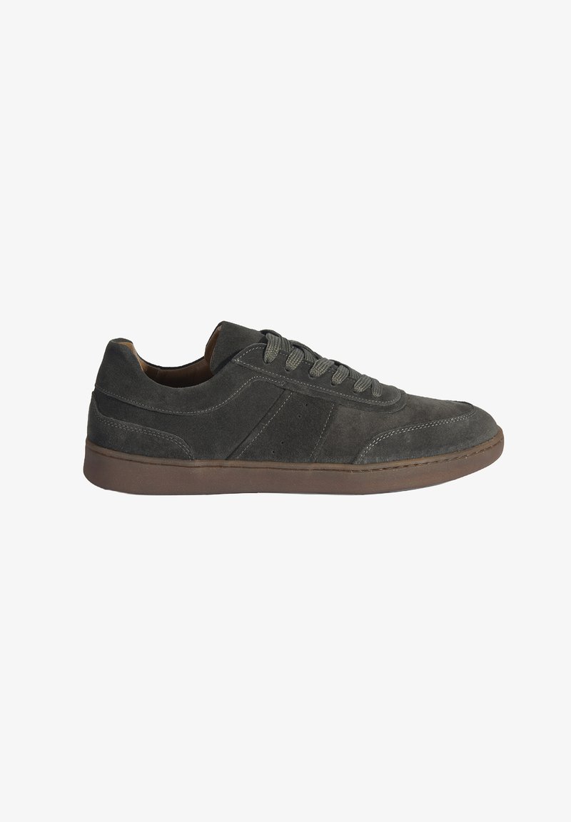 Gray suede sneakers with a low profile, round toe, and contrasting brown rubber sole. Features tonal laces and stitched detailing on the upper.