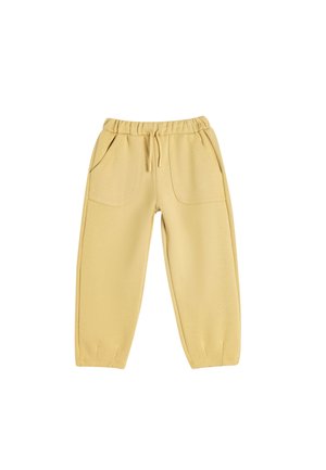 Pantalones de chándal amarillos de algodón con cintura elástica, cordón, dos bolsillos frontales y puños ajustados. Textura suave con un acabado mate.