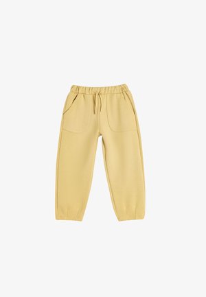 Pantalones de chándal amarillos de algodón con cintura elástica, cordón, dos bolsillos frontales y puños ajustados. Textura suave con un acabado mate.