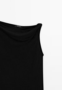 Black sleeveless top with a draped neckline, made from smooth fabric. Features a label inside with “Massimo Dutti” branding.