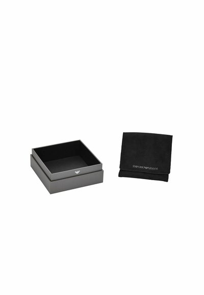Black gift box with a smooth finish and silver logo on the lid, alongside a black suede pouch featuring embossed branding.
