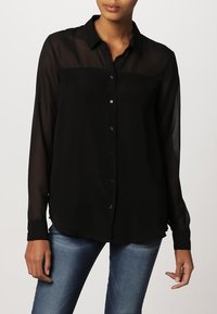 Black, sheer button-up shirt with a collar, long sleeves, and a relaxed fit. Smooth texture with subtle sheen, featuring small black buttons.