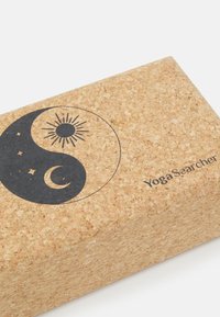 Cork joga blok s yin-yang dizajnom u crnoj boji, s motivima sunca i mjeseca, te "YogaSearcher" brendiranjem u crnoj boji.