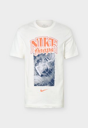 Camiseta blanca de Nike con texto naranja "Nike Hoops", un balón de baloncesto azul detrás de un gráfico de valla de eslabones y un logotipo naranja de Nike debajo.