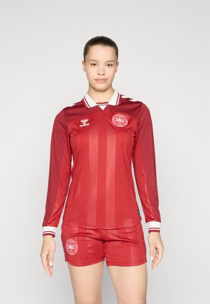 Red soccer jersey with long sleeves, white collar and stripes, paired with matching shorts featuring a round logo on the thigh.
