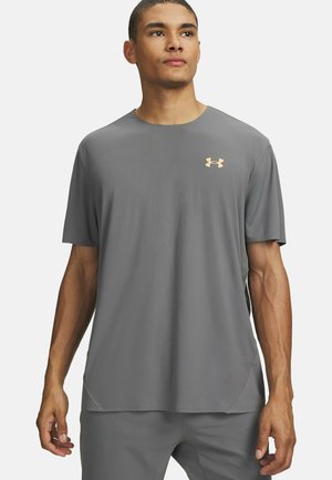 Gray athletic t-shirt with short sleeves, made from smooth material. Features a small golden logo on the chest and side slits for flexibility.